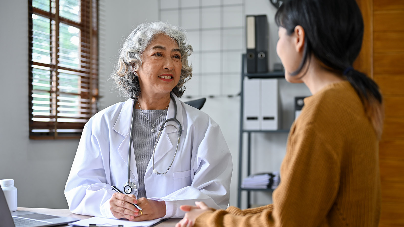 woman having a friendly conversation with her doctor