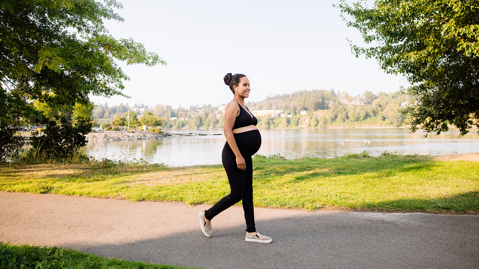 Pregnant woman walking by the lake