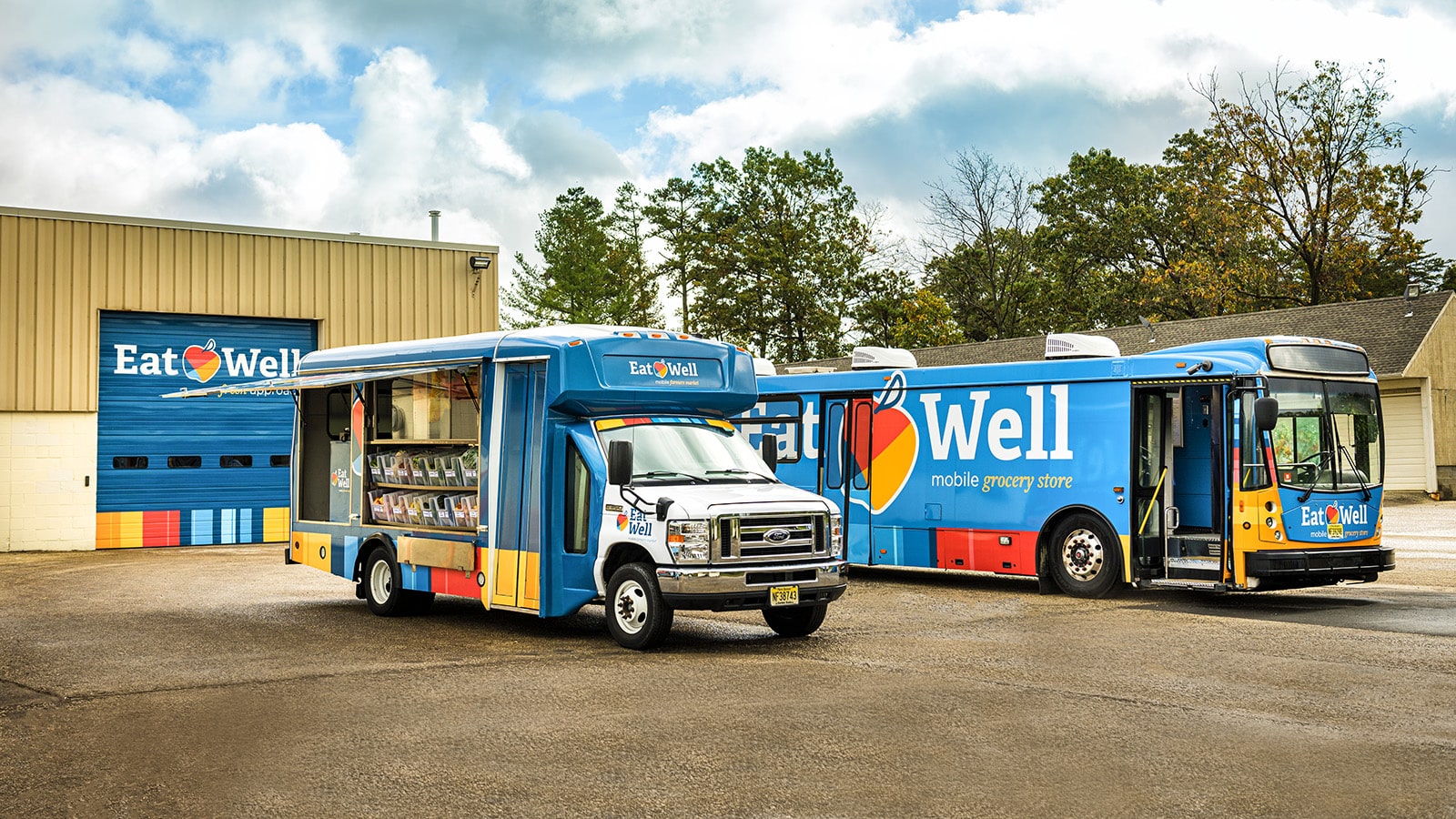 Eat Well trucks parked outside in a parking lot