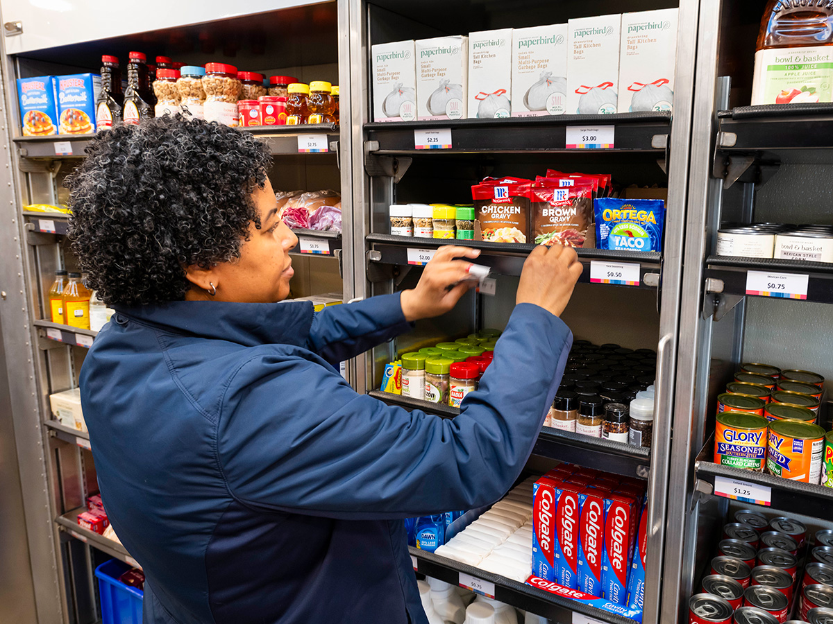 Female staff member organizing shelves at Virtua Mobile Grocery Store