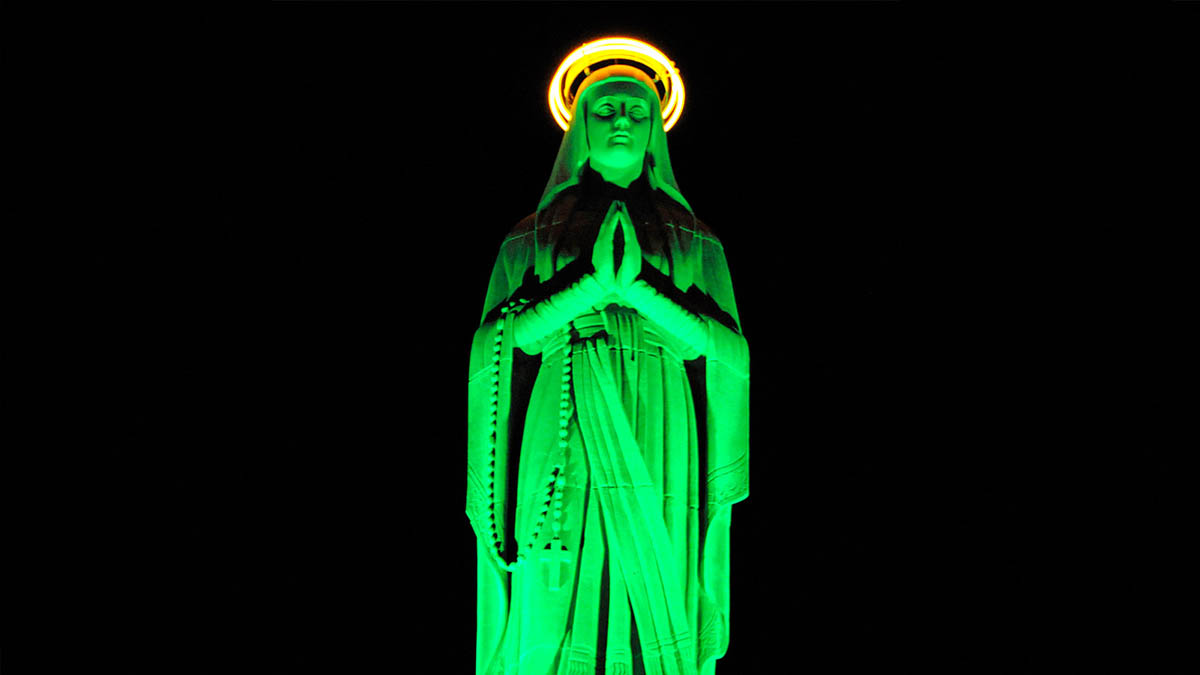 Our Lady of Lourdes statue is lit in green to hone patients each time a transplant is performed