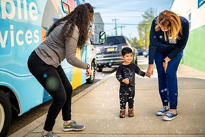 Pediatric Mobile Services child playing with bubbles