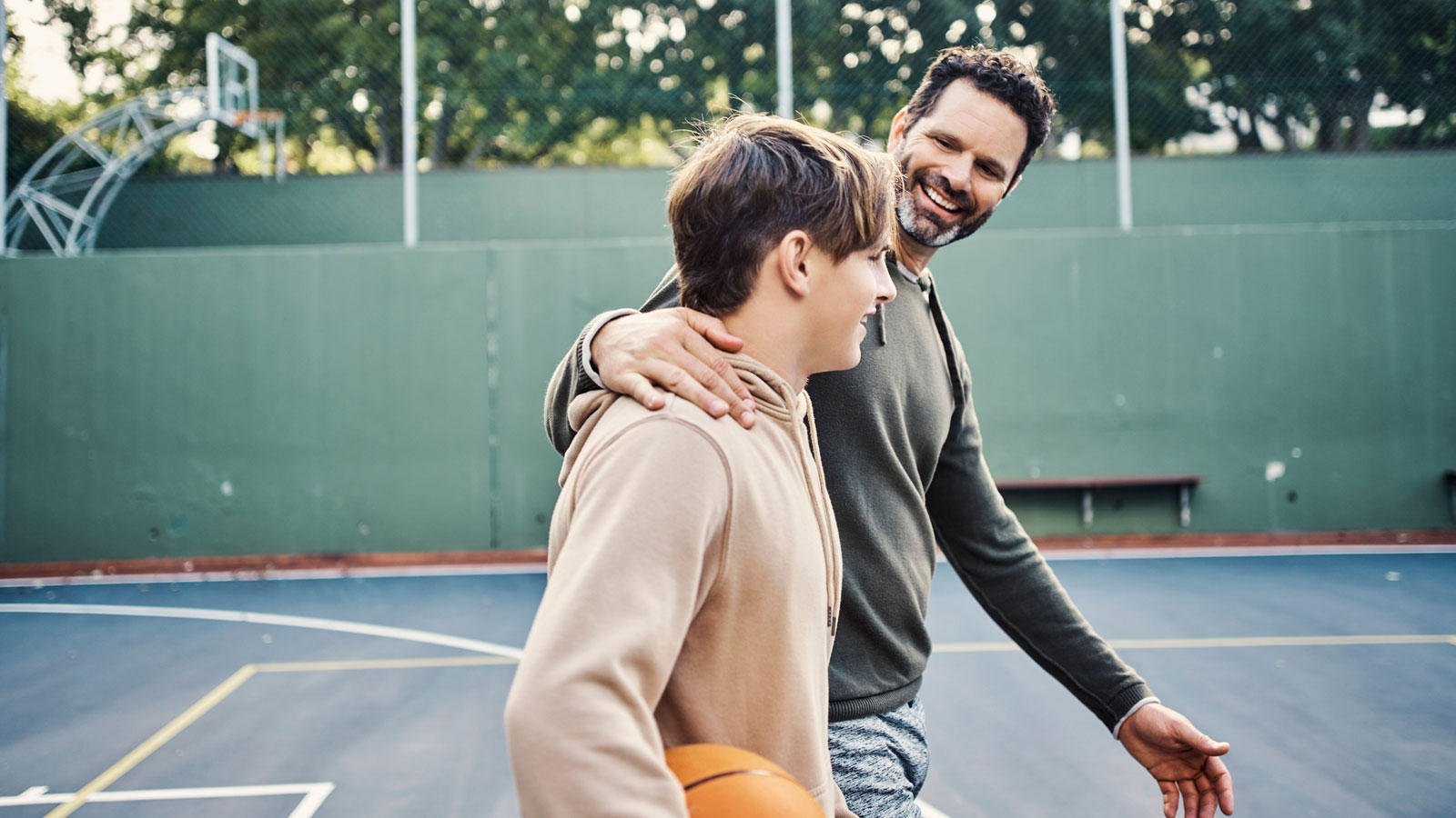 father playing basketball with his son