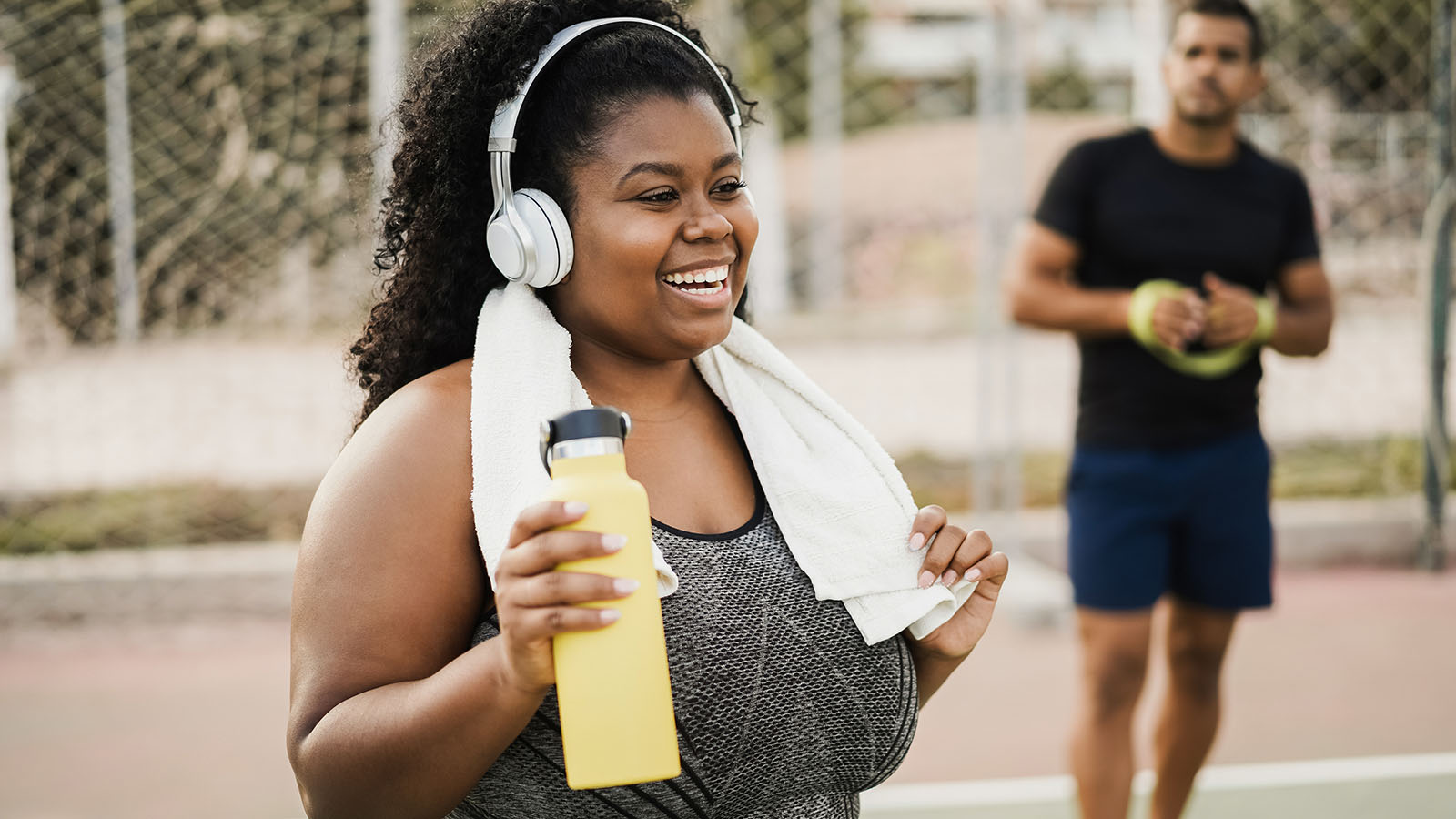 Young woman listening to music and cooling off after a workout