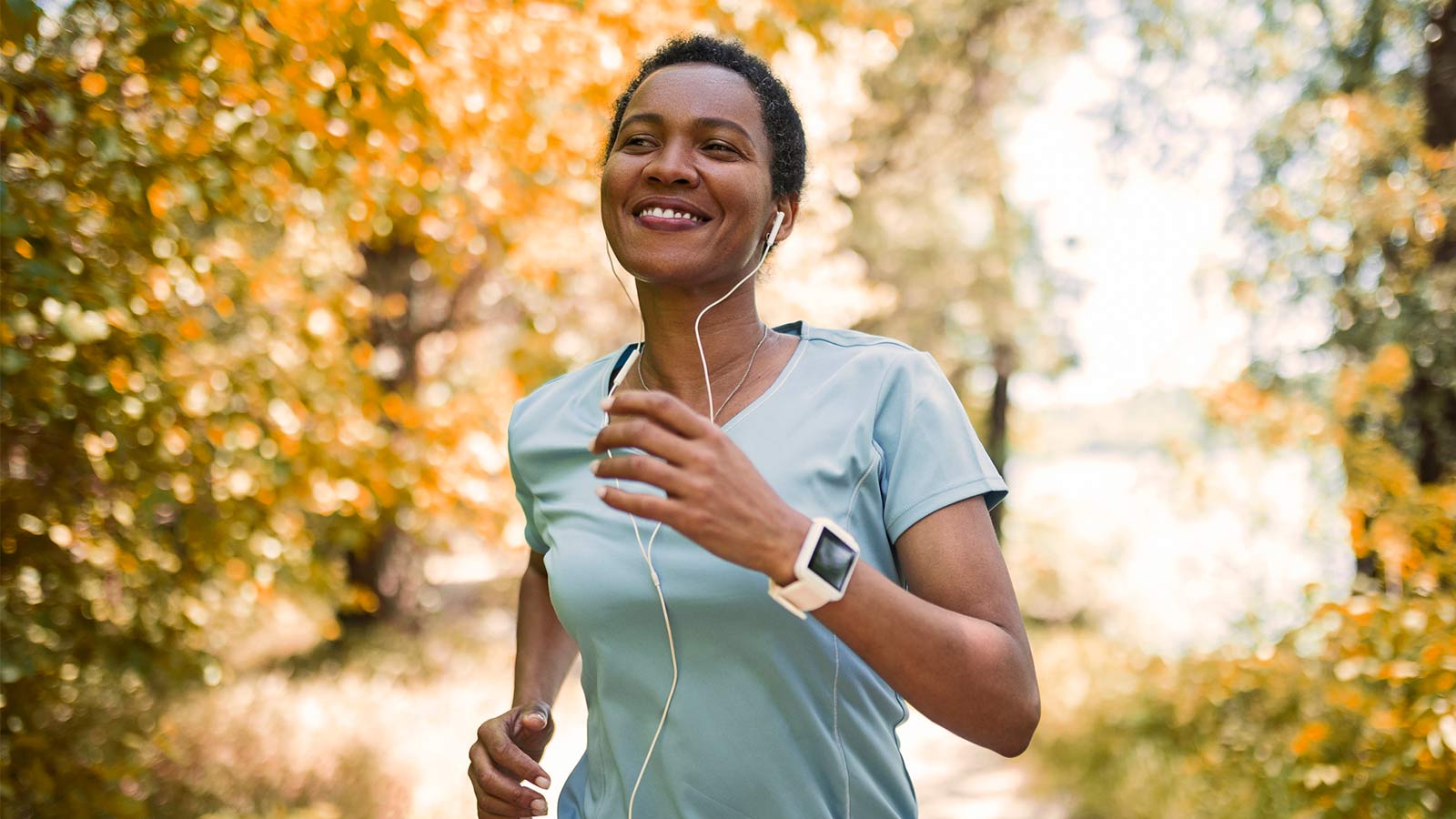 woman enjoying a run in the woods during autumn