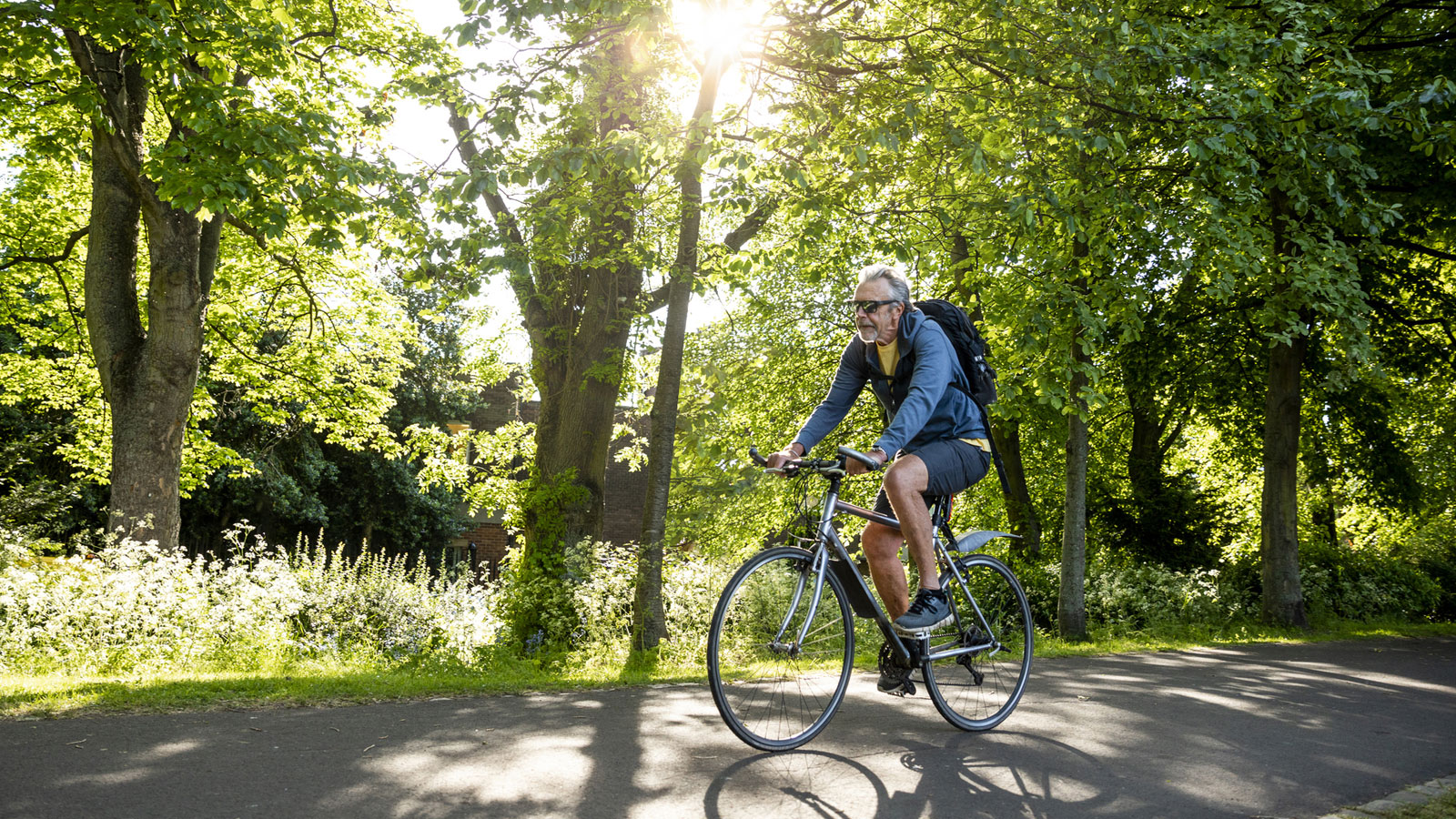 man riding bike on scenic trail