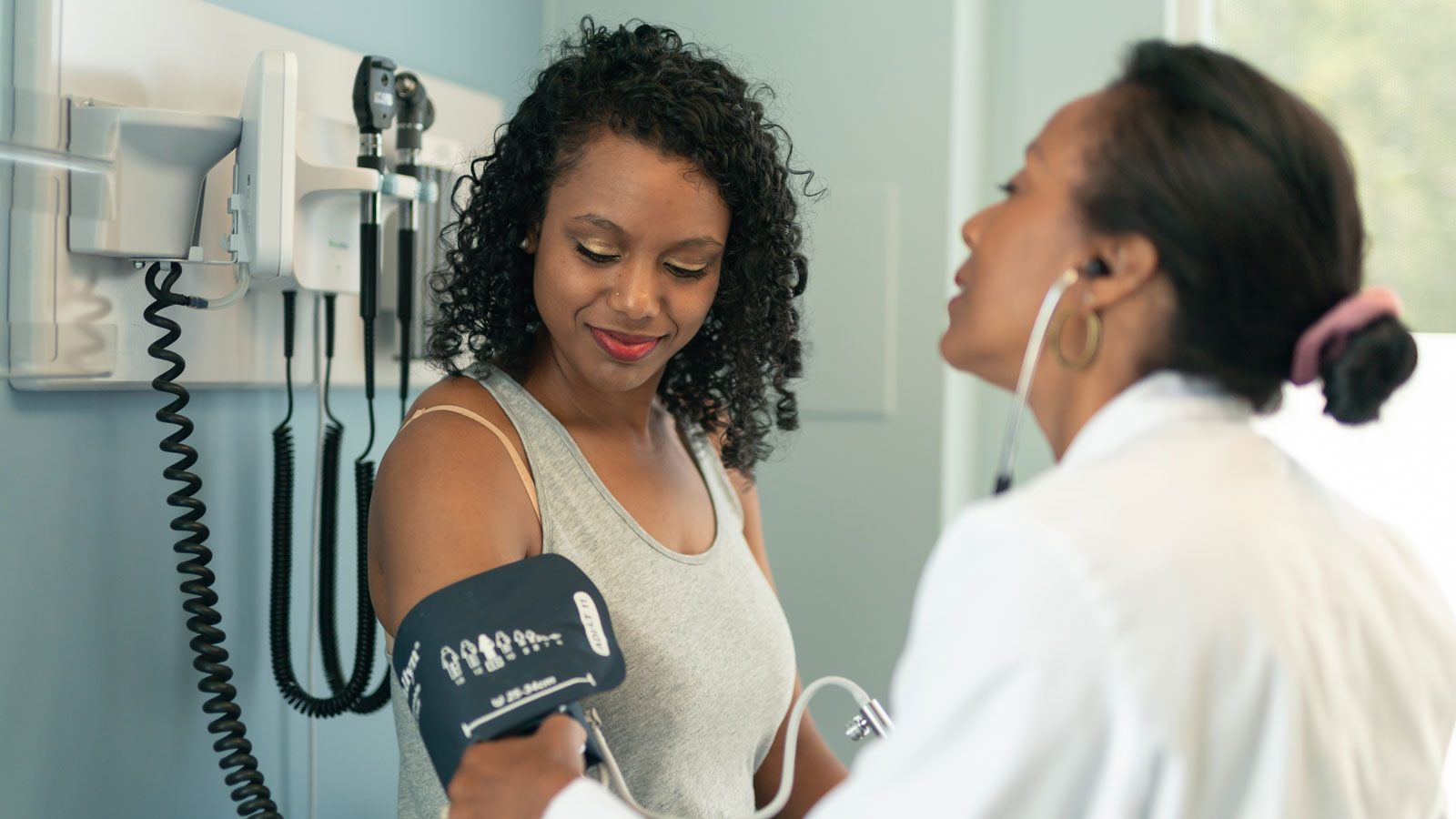 woman having her blood pressure taken at the doctor's office