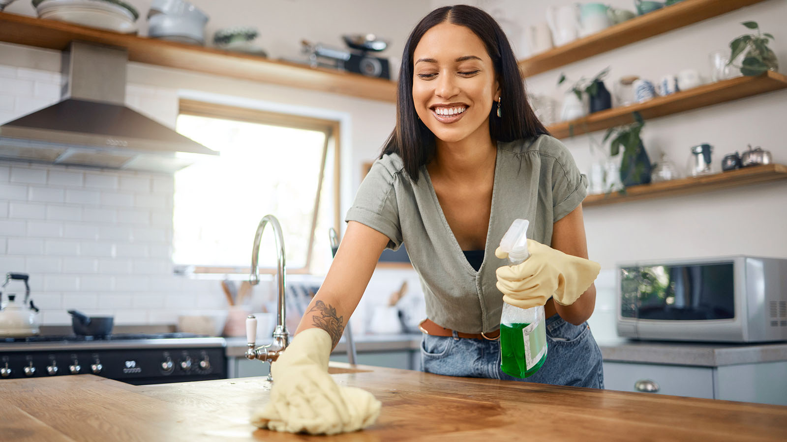 young adult female wiping kitchen table