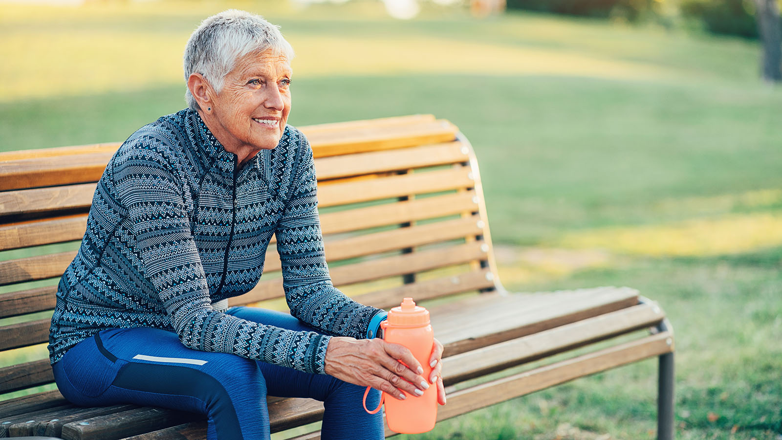 Senior woman takes a water break after exercising