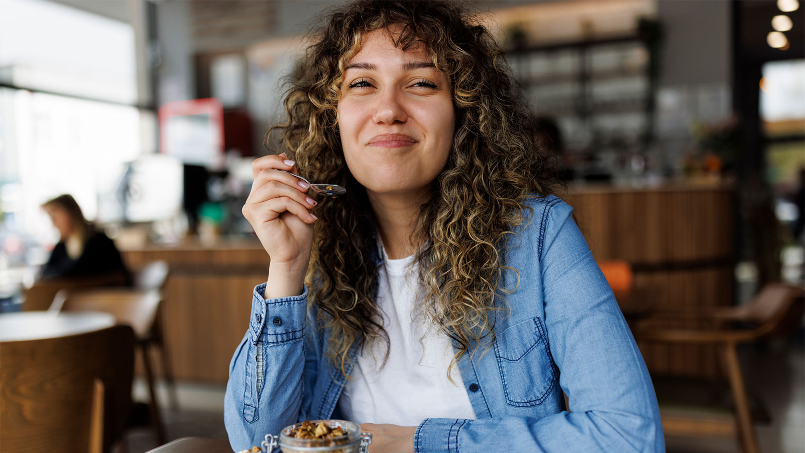 young woman enjoying a healthy snack at a cafe