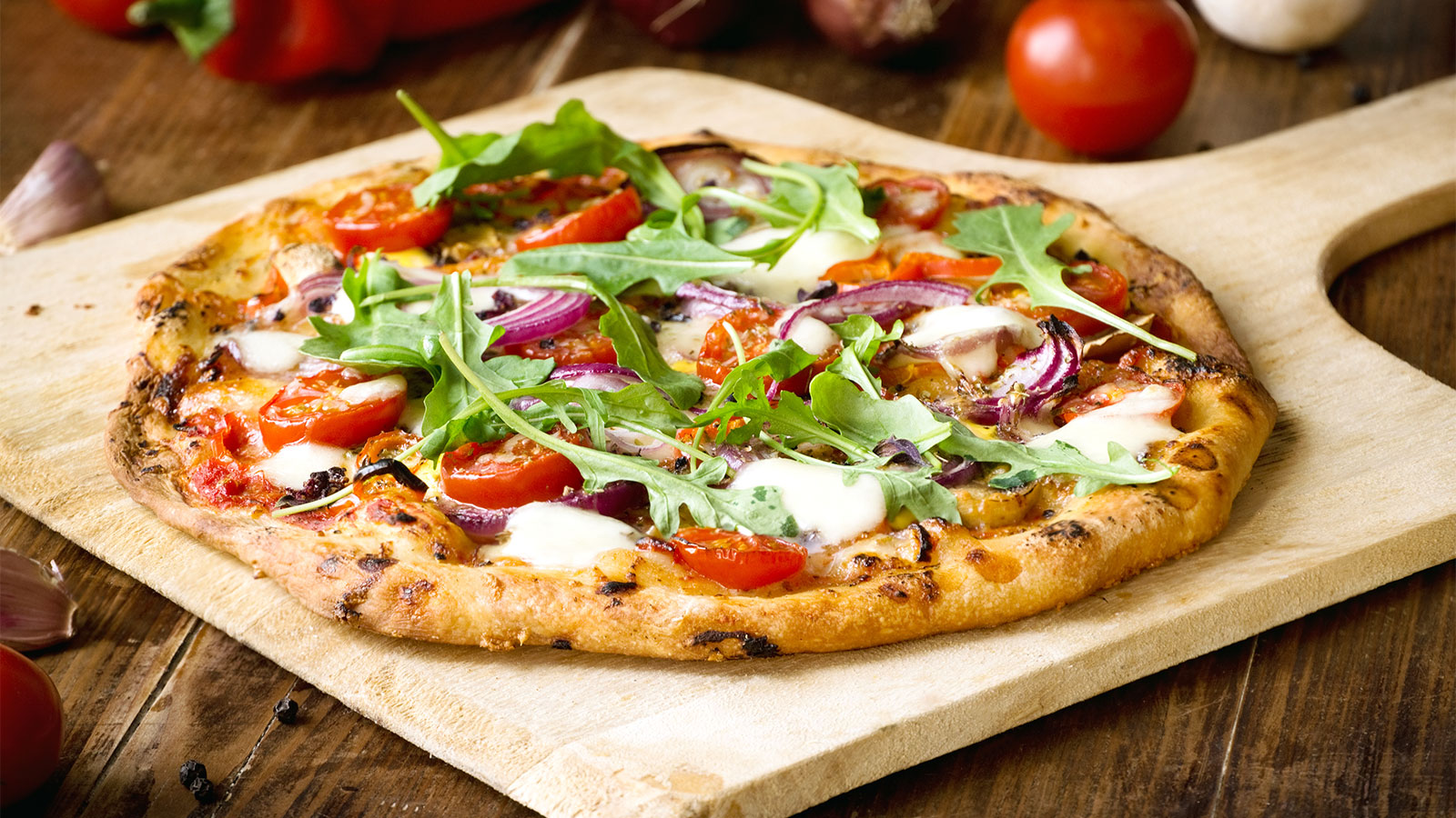 homemade pizza displayed on a pizza board