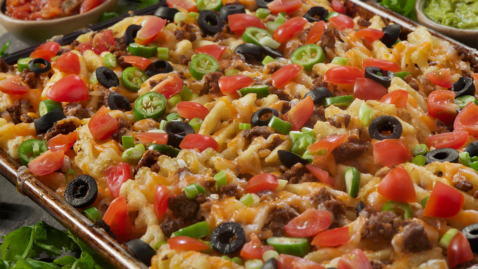 homemade nachos arranged on a sheet pan