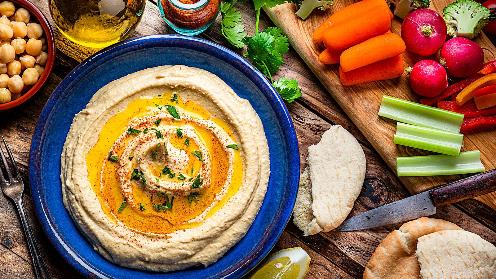 hummus and veggies arranged on a serving tray
