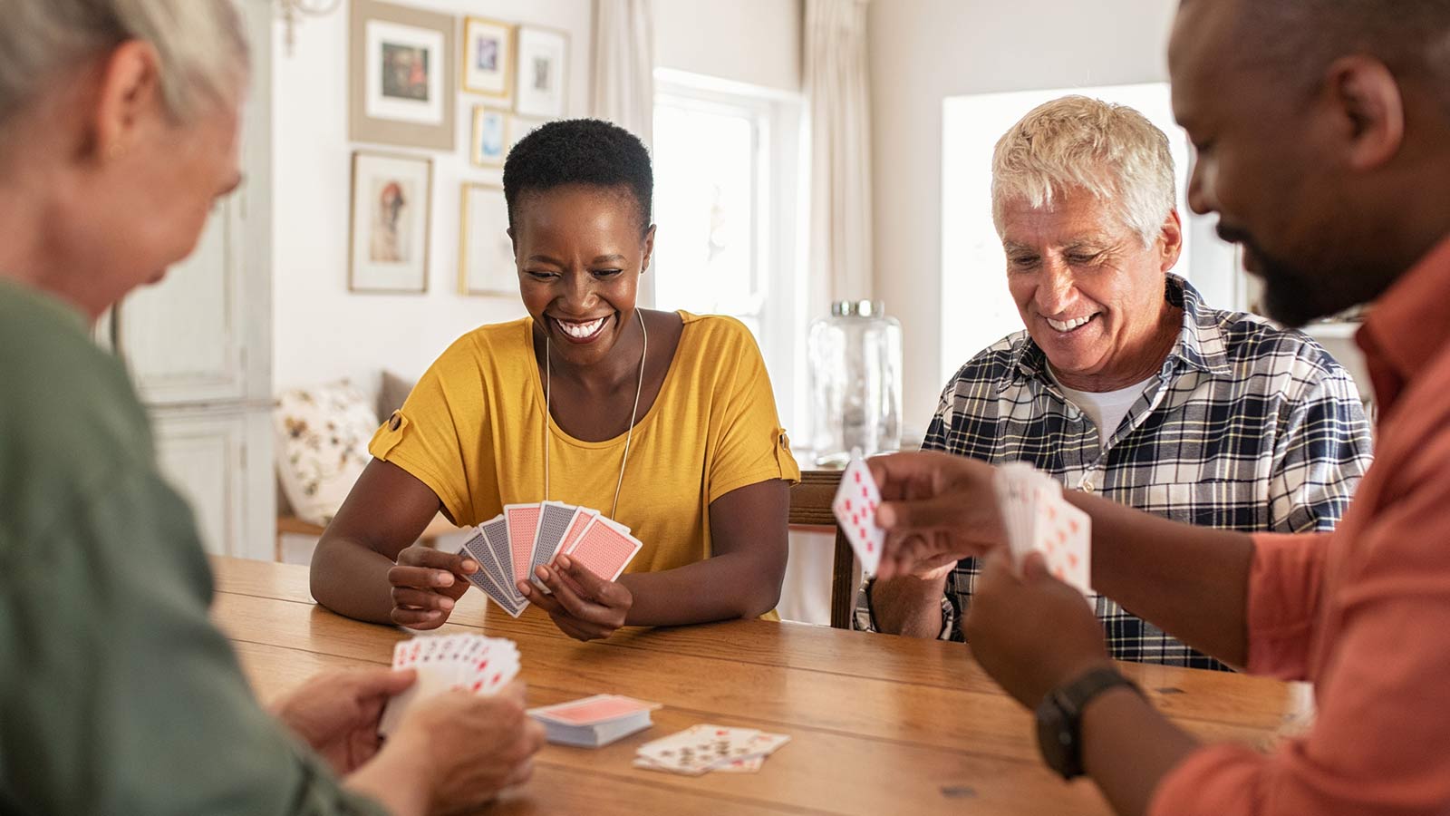 four family members playing a game of cards together