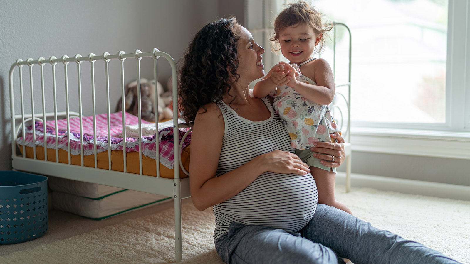 pregnant mother enjoying spending time with her young daughter