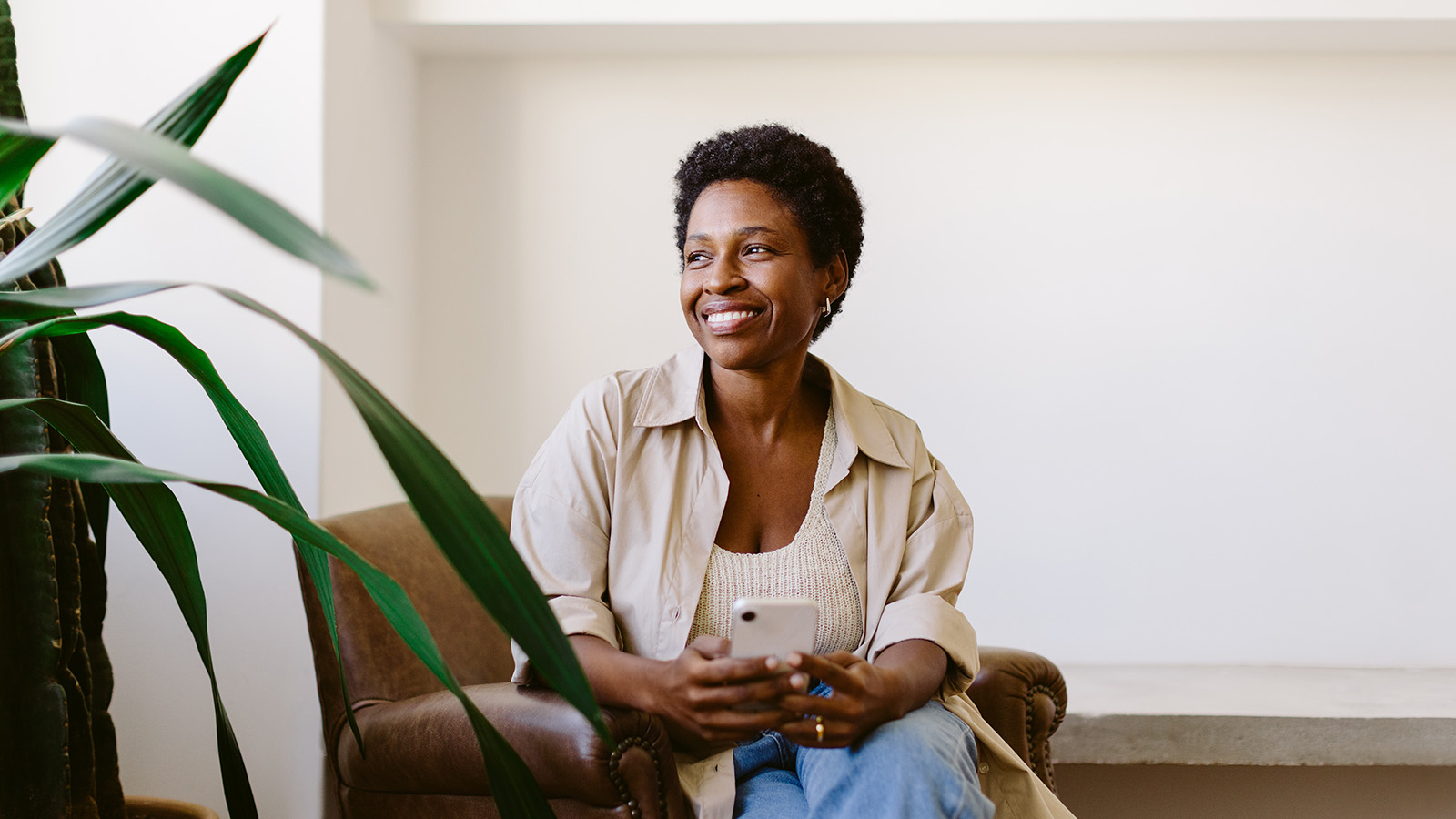 Middle-aged woman smiling and looking out an unseen window in a physician's office