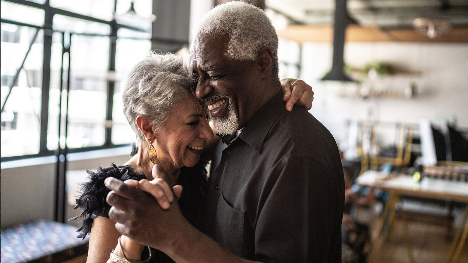 Senior couple laughing and dancing together