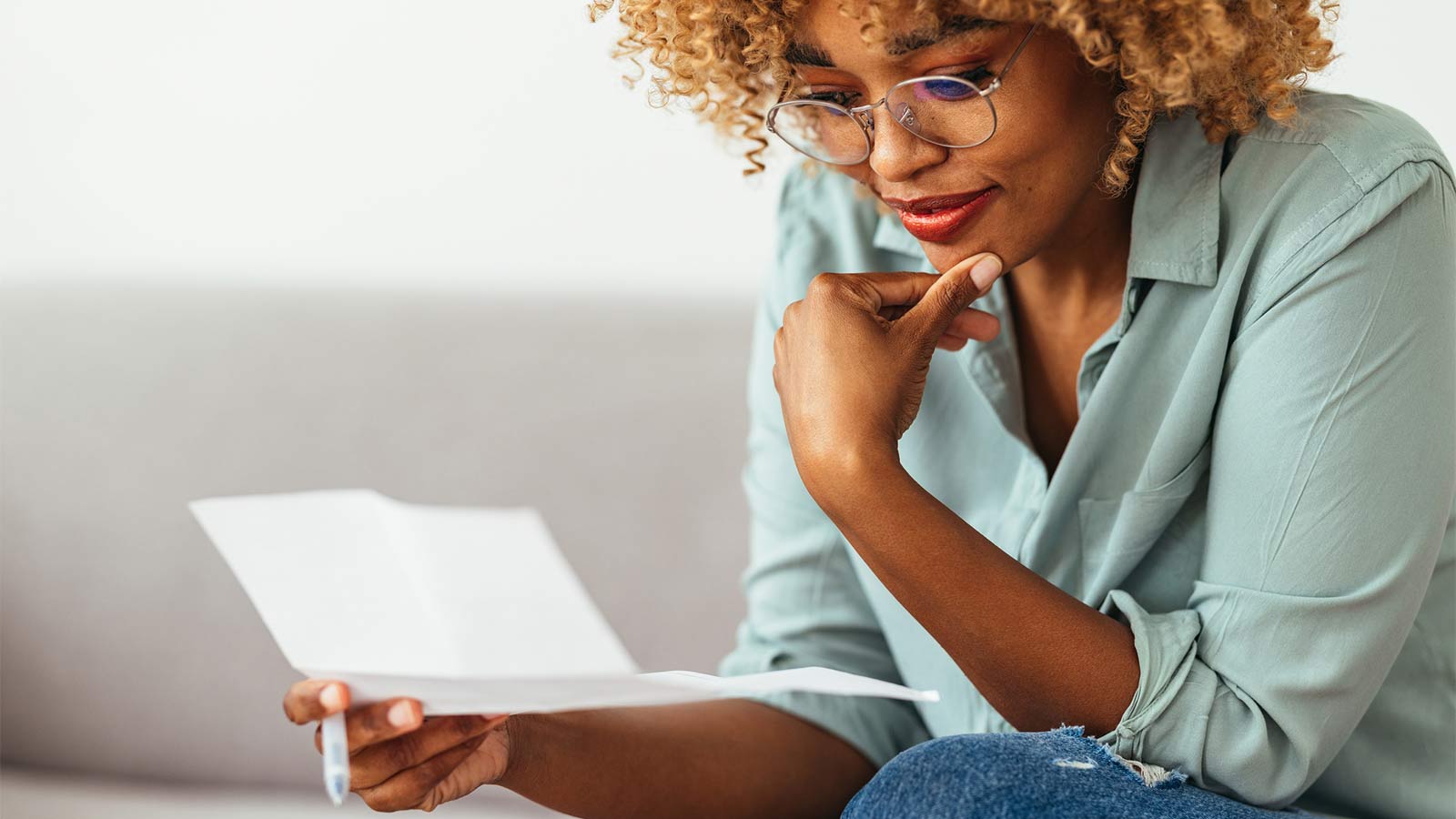 woman looking at test results on a sheet of paper