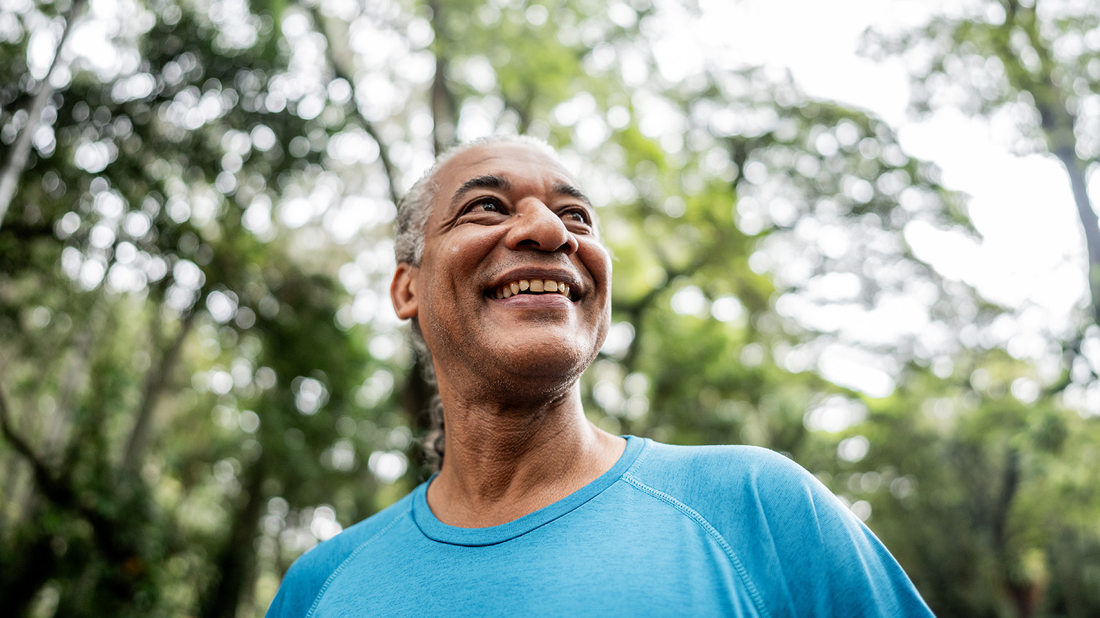 senior man smiling in outdoor setting