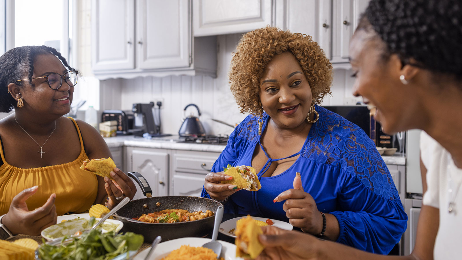 group of women enjoying a meal at home together