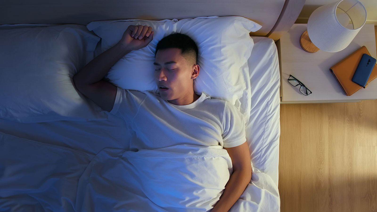 young man in bed sleeping deeply