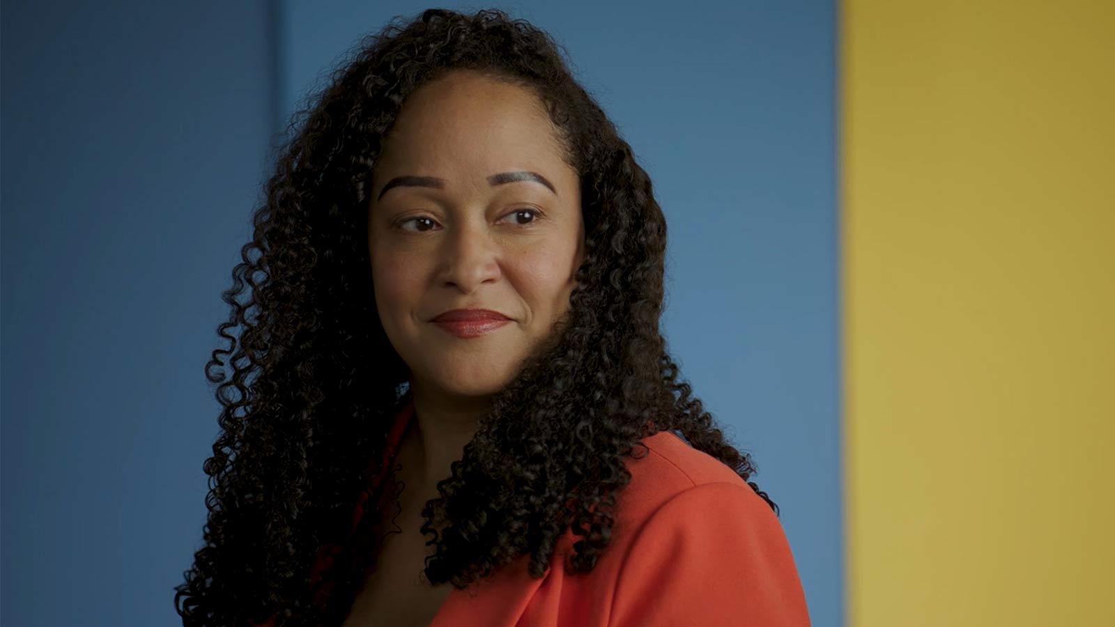 woman smiling and looking off camera