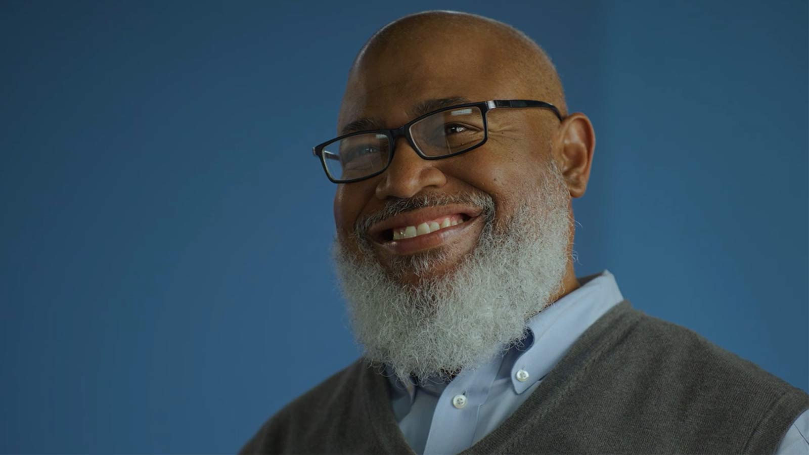 man smiling and looking at the camera