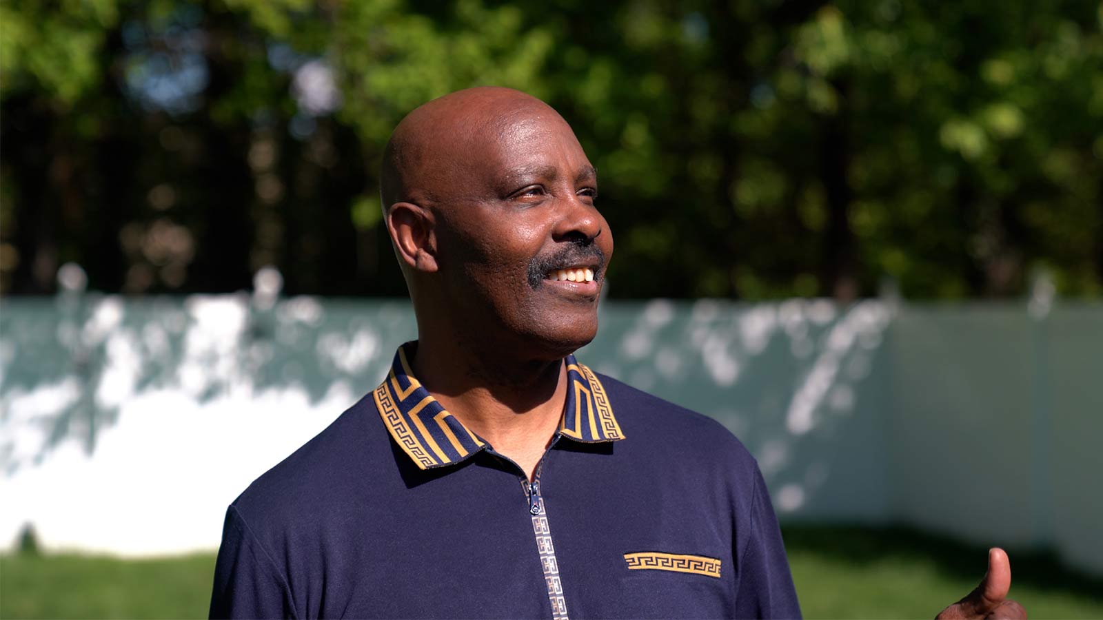man smiling while looking off camera