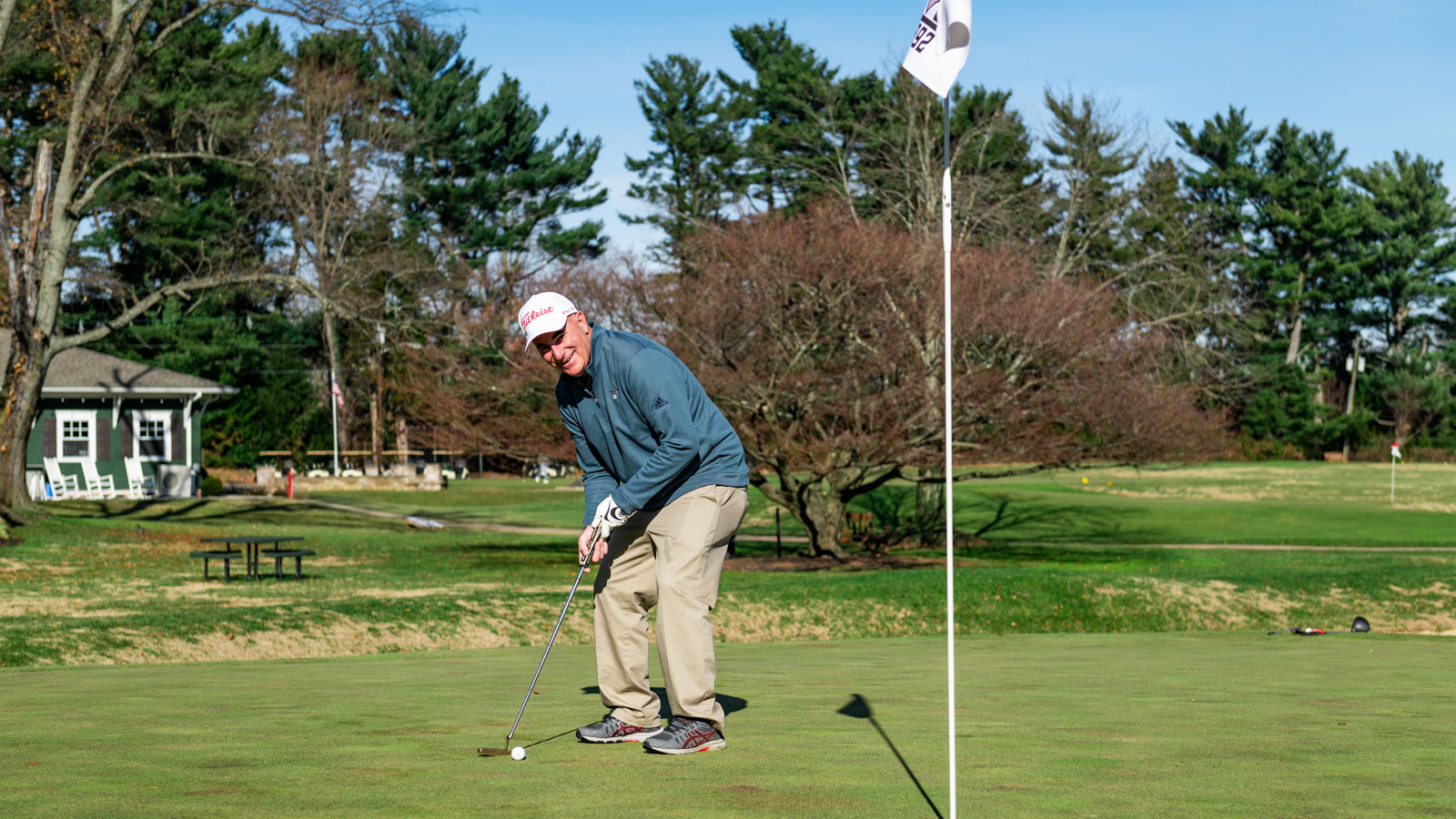 man teeing off on the golf course