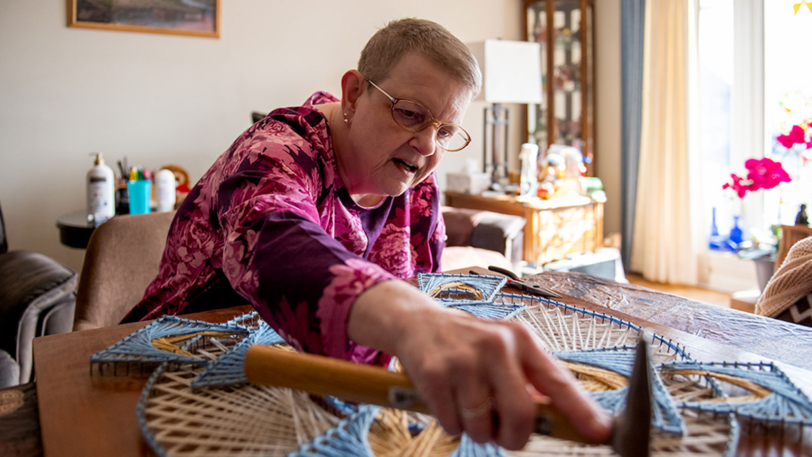Kidney transplant patient working on a craft project at home