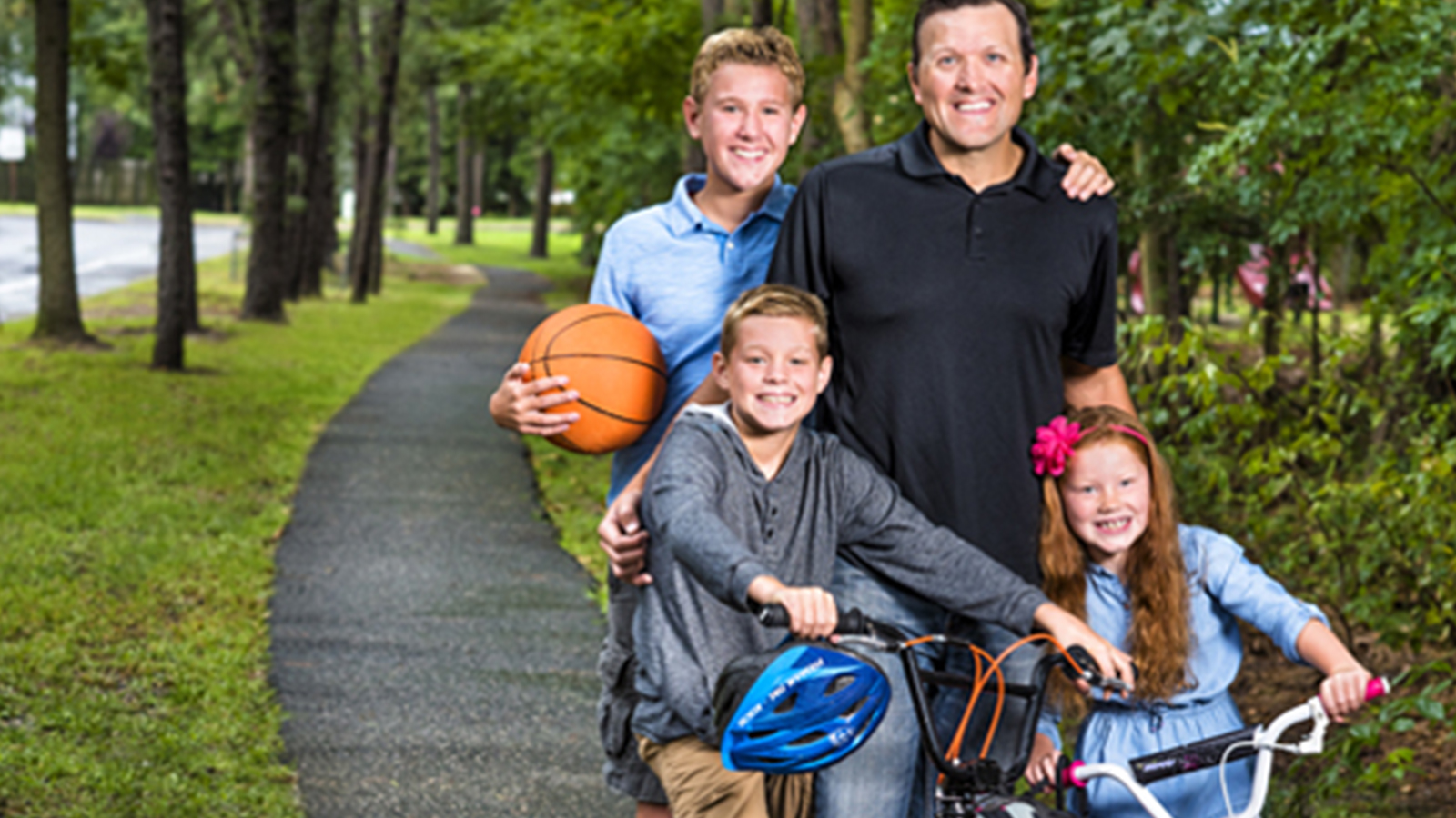 back surgery patient and his children doing outdoor activities together