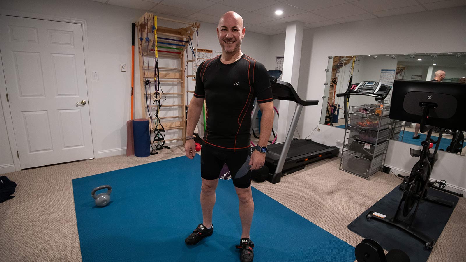 athletic man wearing workout gear standing in his home gym
