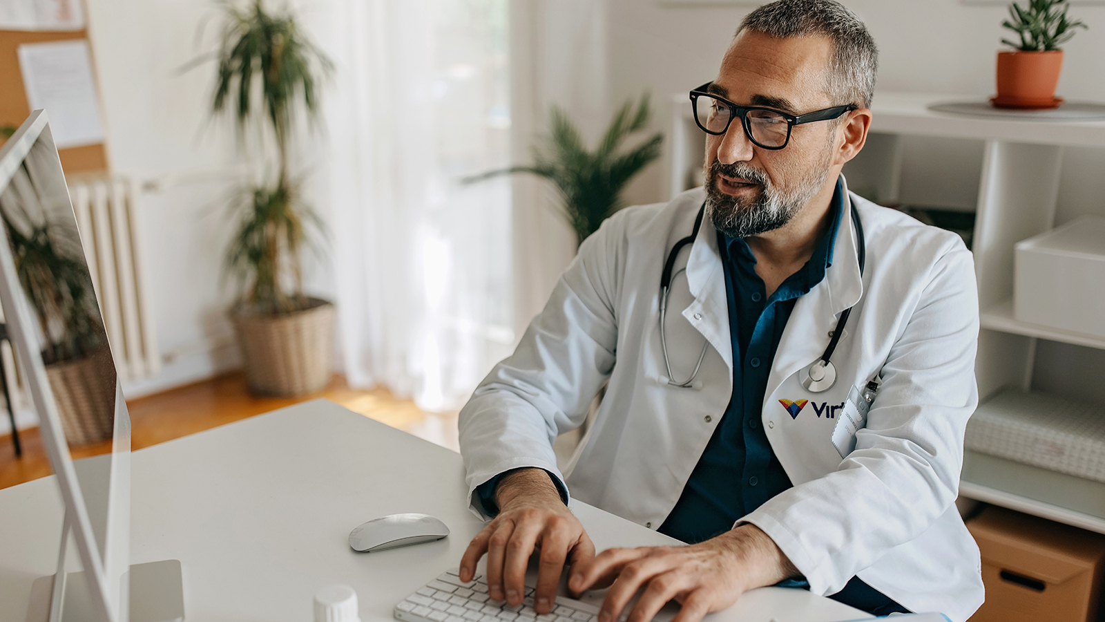 Male doctor working on a computer