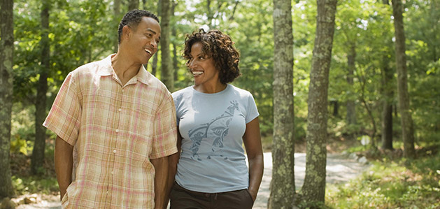 Two people walking through a park