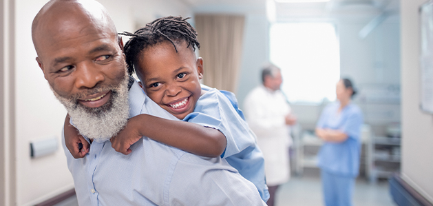 Man giving child piggyback ride