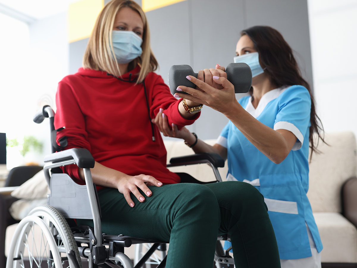 women in wheel chair getting physical therapy