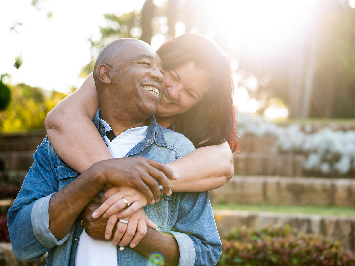 Adult couple embrace outdoors