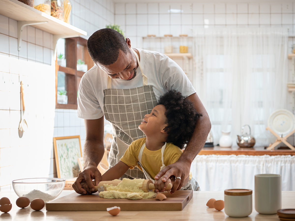 Father baking in kitchen with child