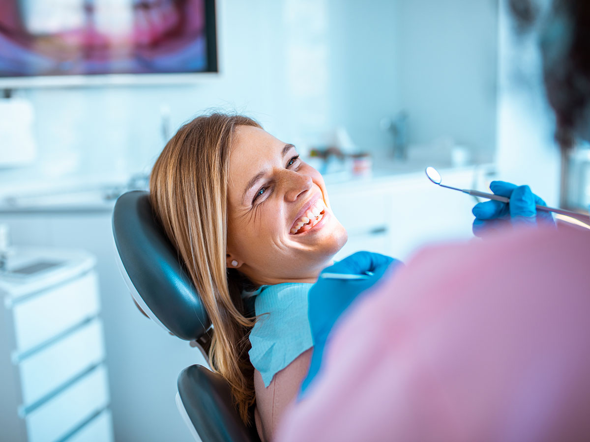 Woman smiling in a dentist chair