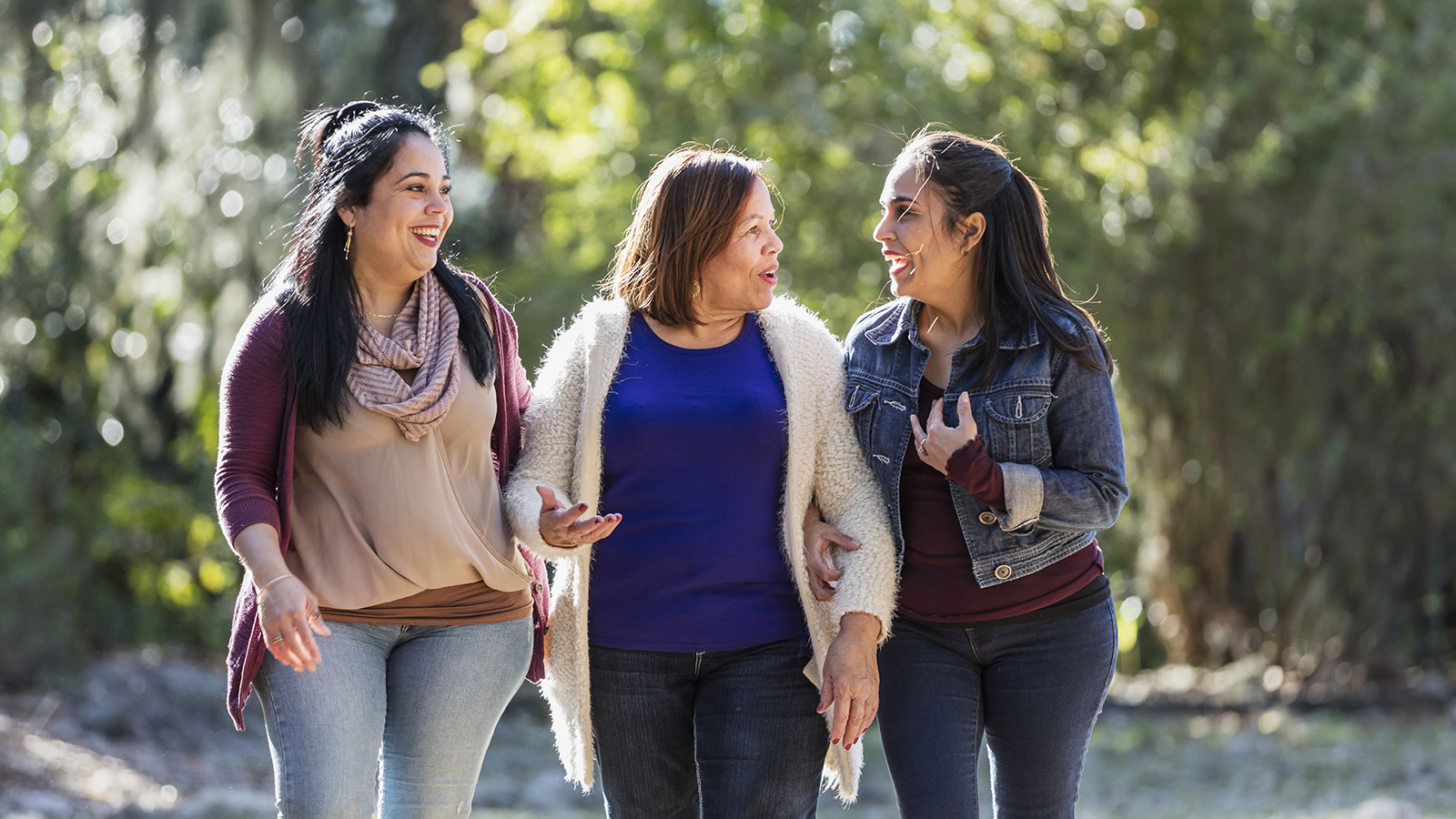 Three women walking and laughing