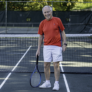 Buz Murphy playing tennis.