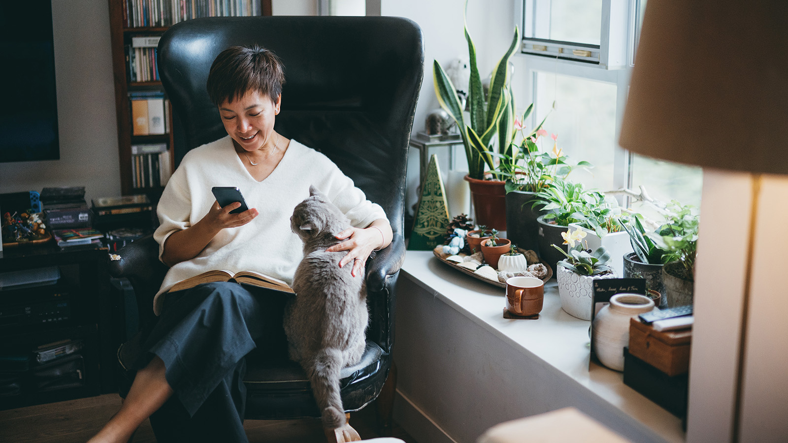 Woman reclining in chair with cat