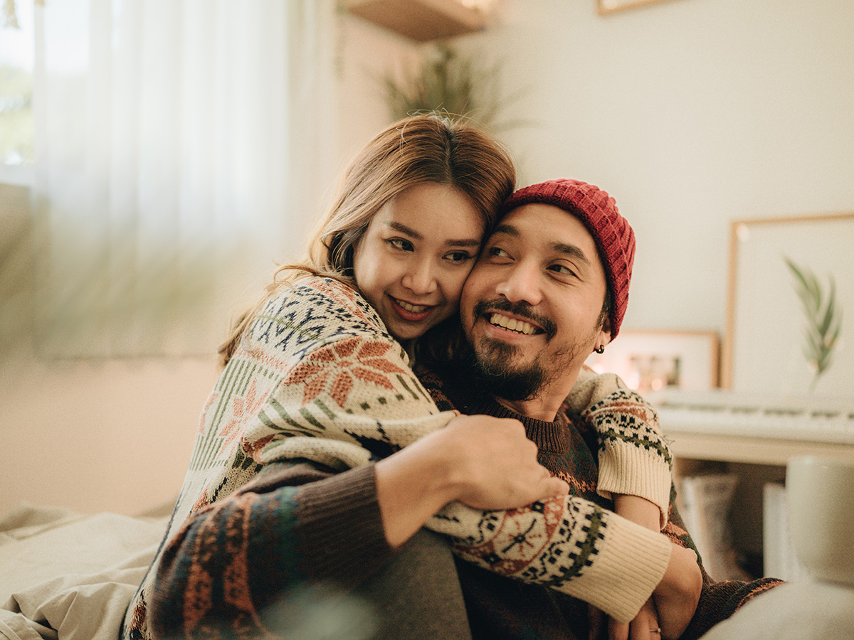 Young couple embraces on the couch