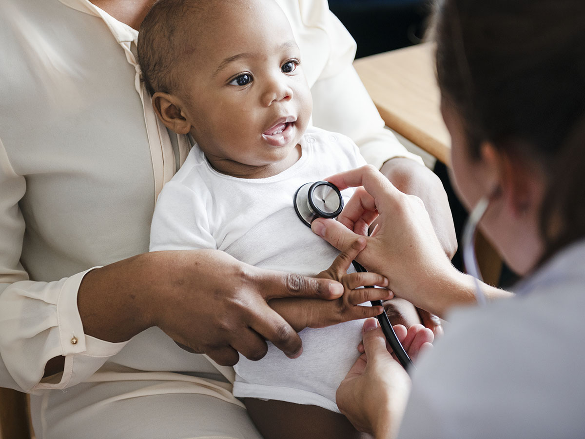 Doctor listening to baby's heart beat