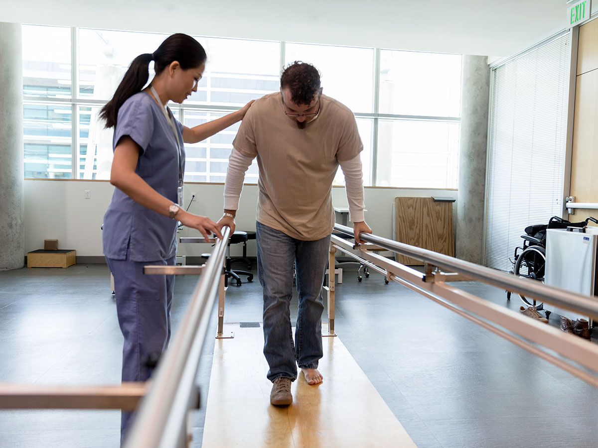 Man getting walking therapy