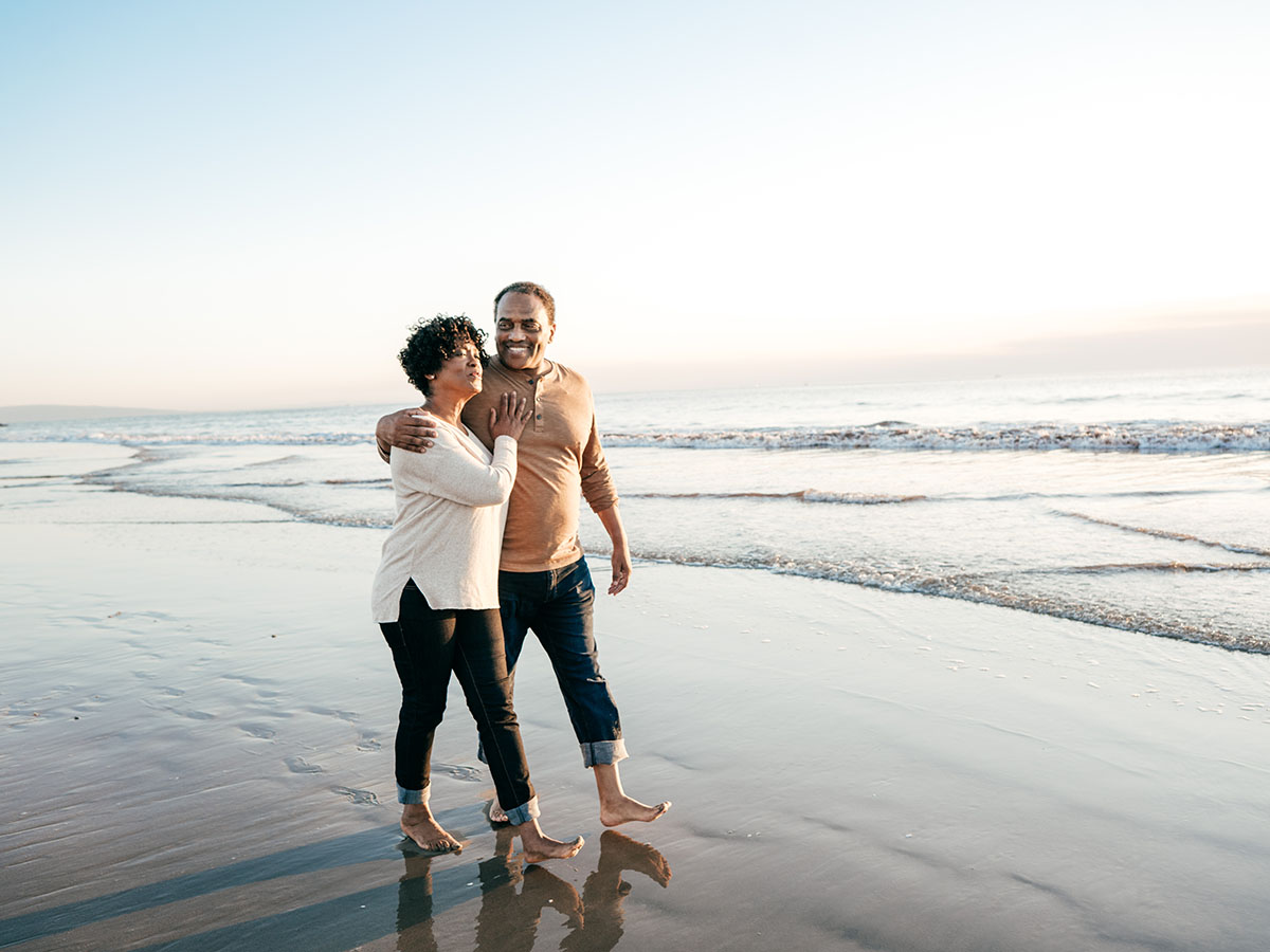 Senior African American couple walking on the beach