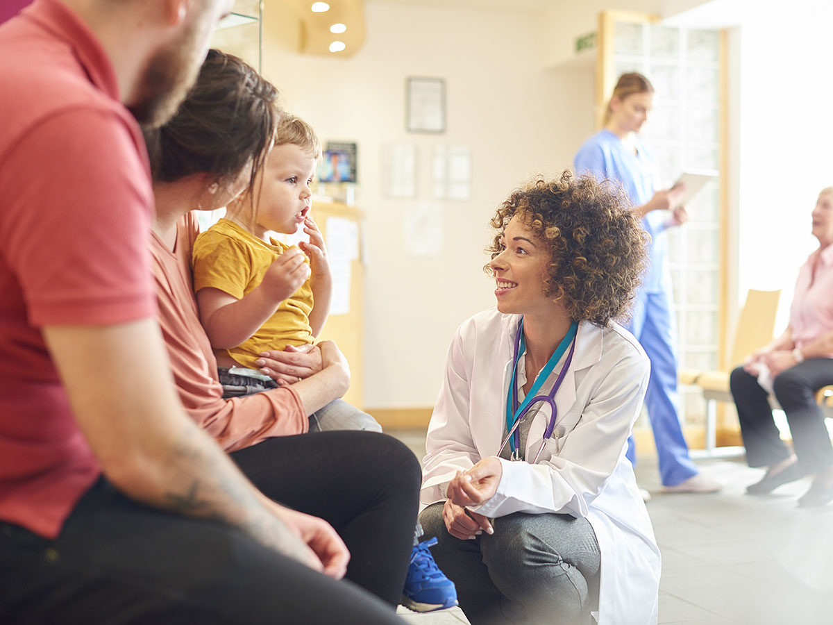 Doctor with parents and child