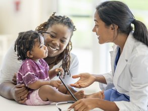 Doctor with mother and child