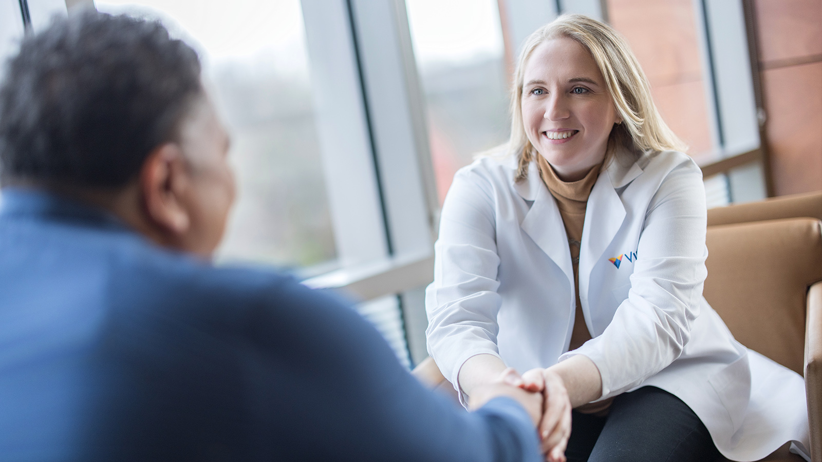 Virtua robotic surgeon speaks to a patient