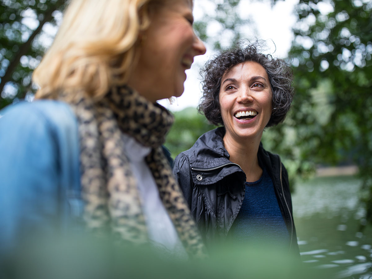 Two happy mature women in forest